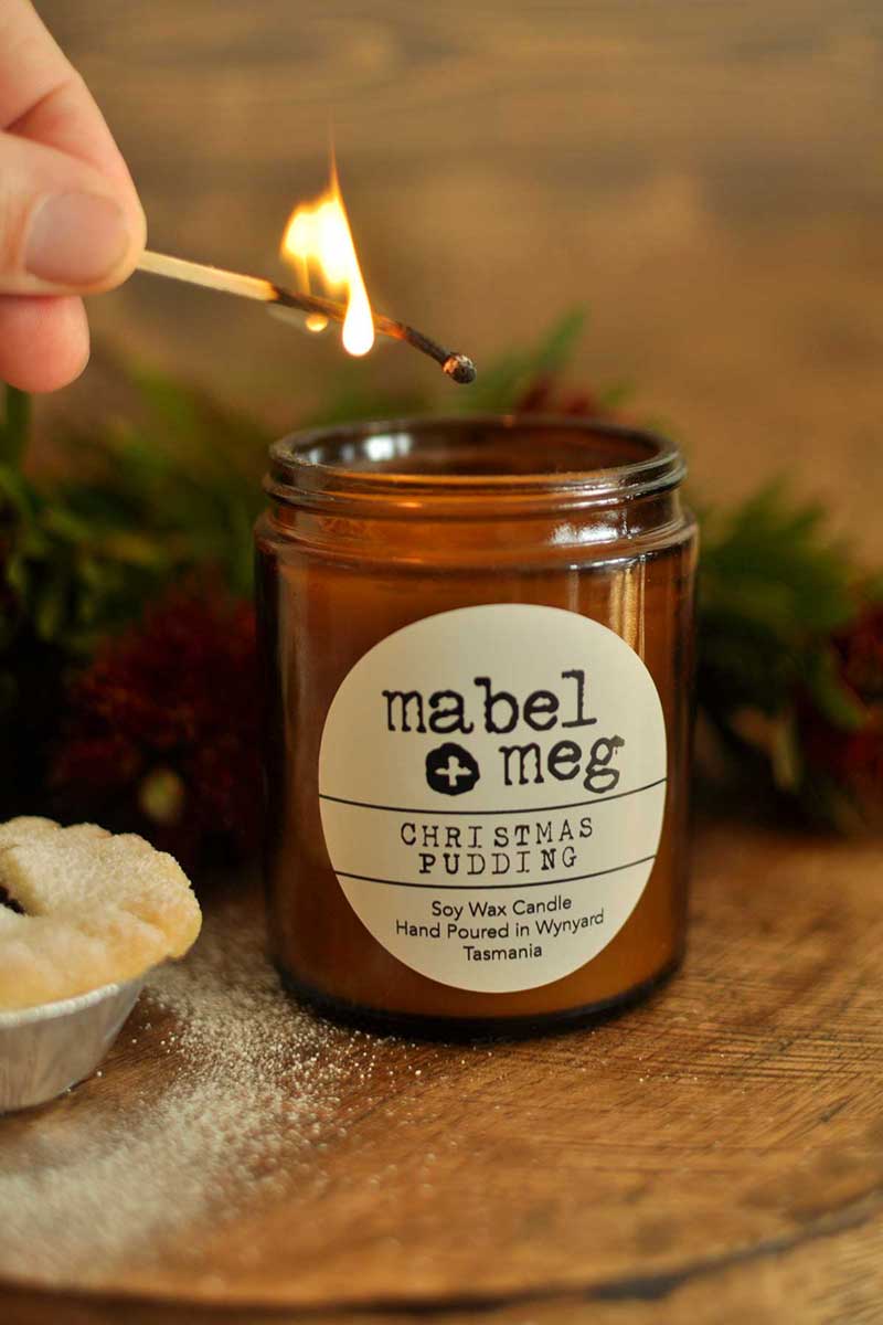 Scented Candle by Mabel + Meg in Christmas Pudding classic  being lit