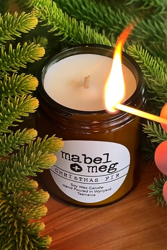 Scented Candle by Mabel + Meg in Christmas Fir Classic being lit