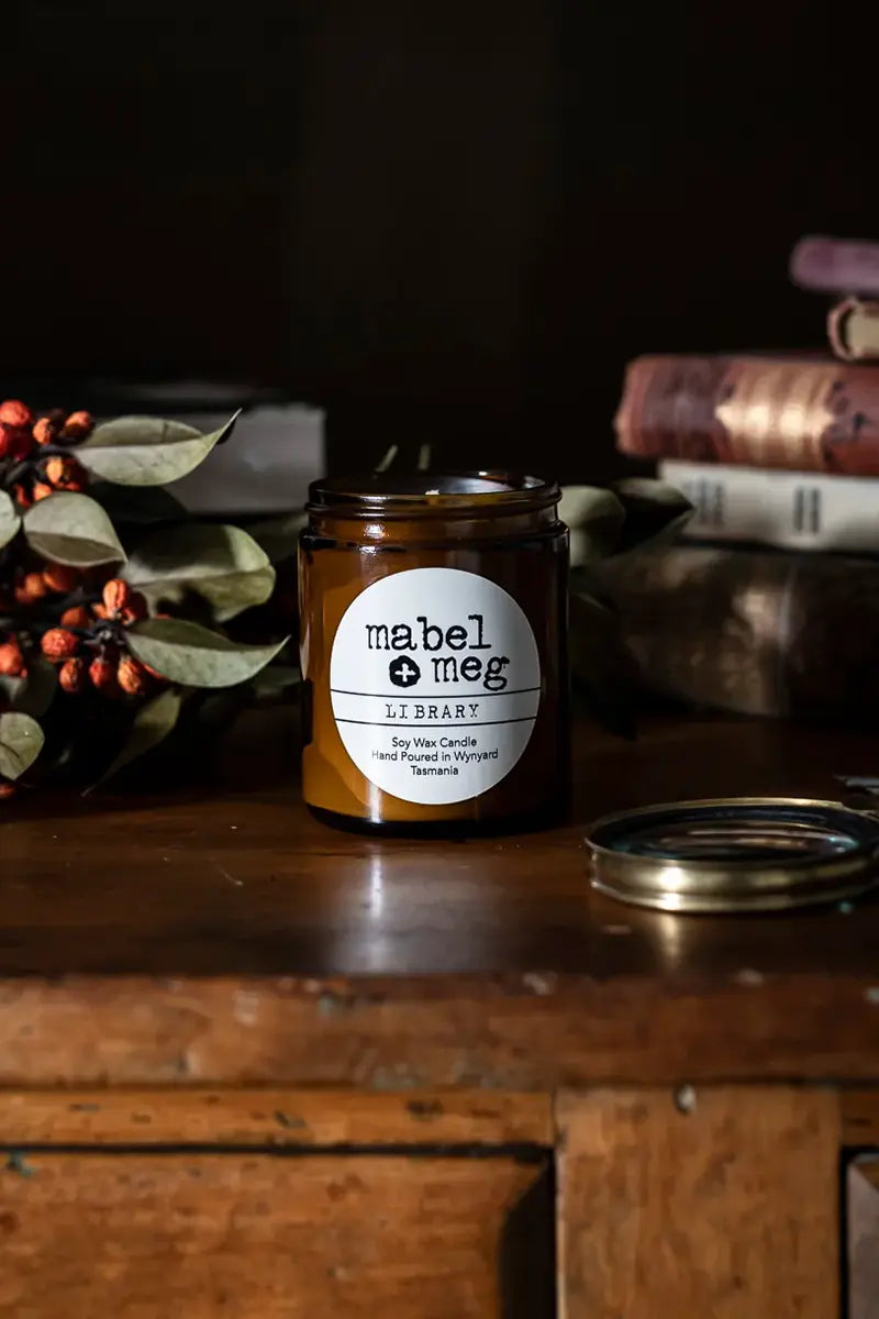 Scented Candle by Mabel + Meg in Library Classic on desk with books