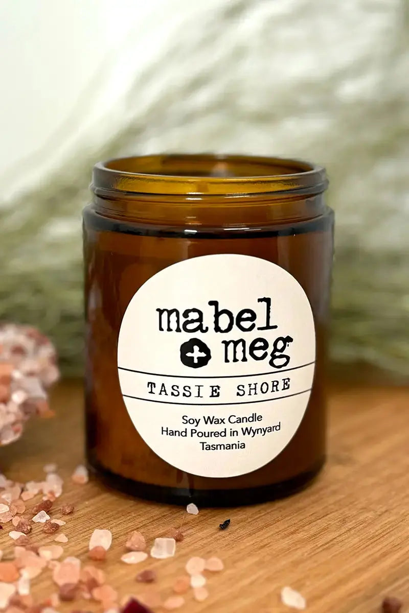 Scented Candle by Mabel + Meg in Tassie Shore Classic un-lit on desk with bath salts