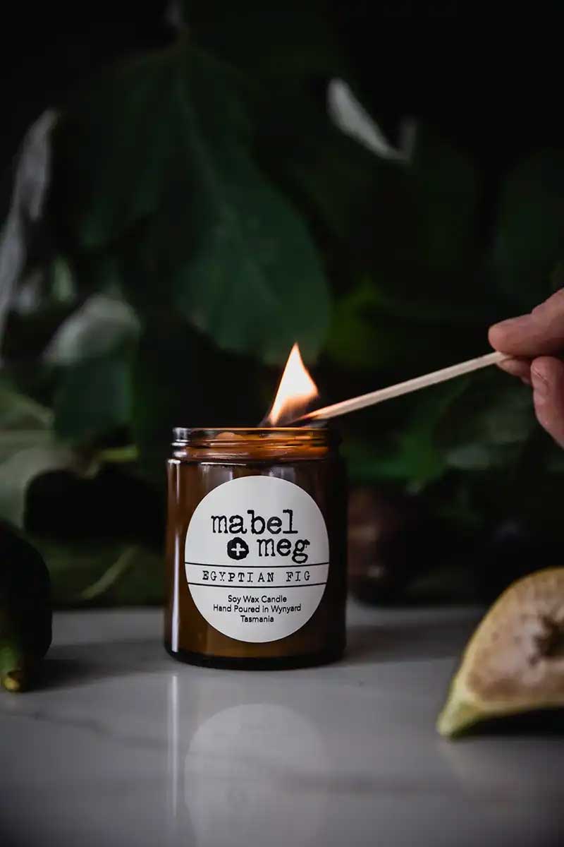 Scented Candle by Mabel + Meg in Egyptian Fig Classic being lit