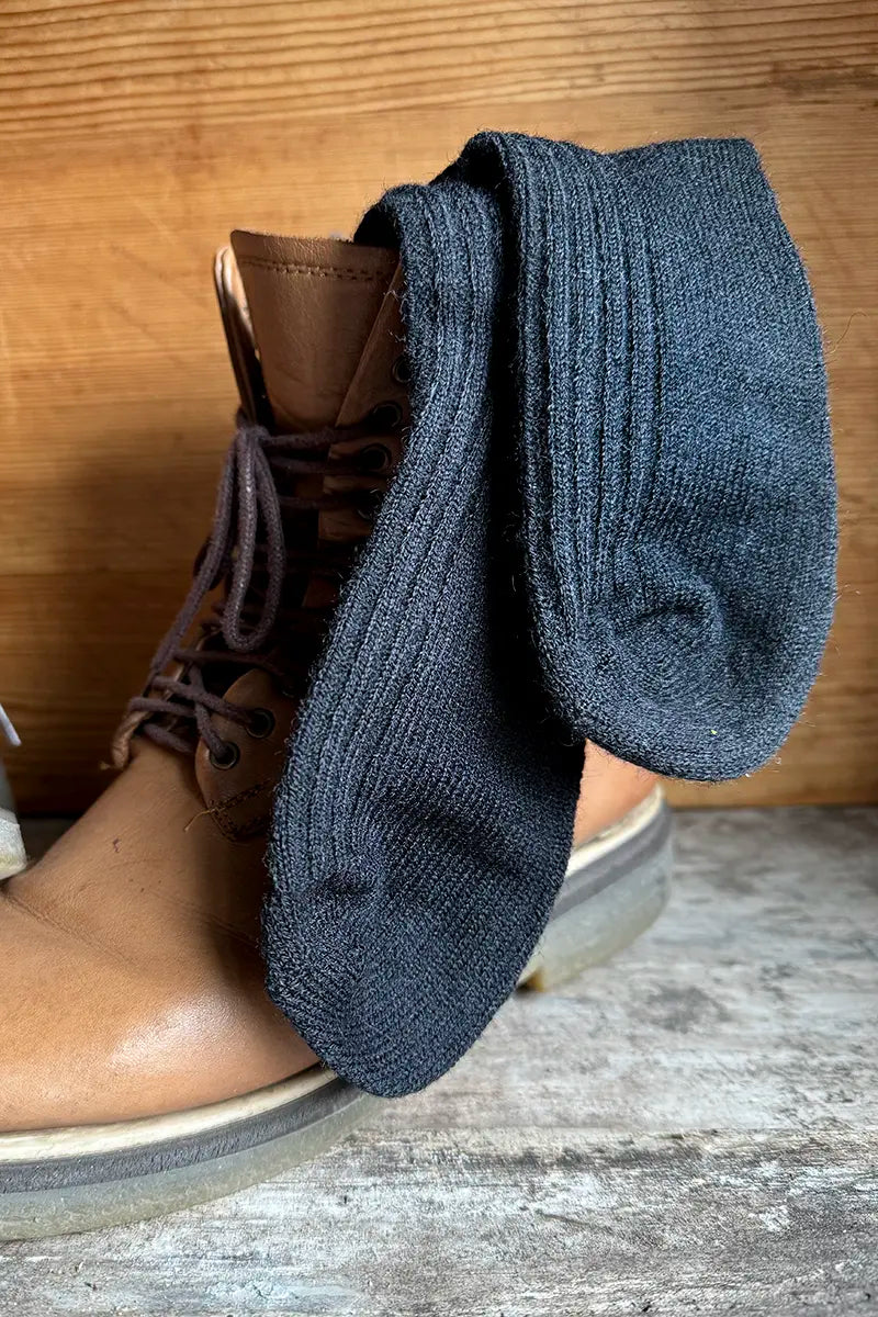 Wool Blend Crew Socks in Black by Mabel + Meg handing out of boot