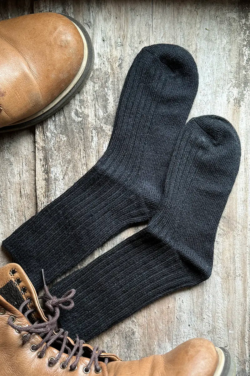 Wool Blend Crew Socks in Black by Mabel + Meg with boots on the bench